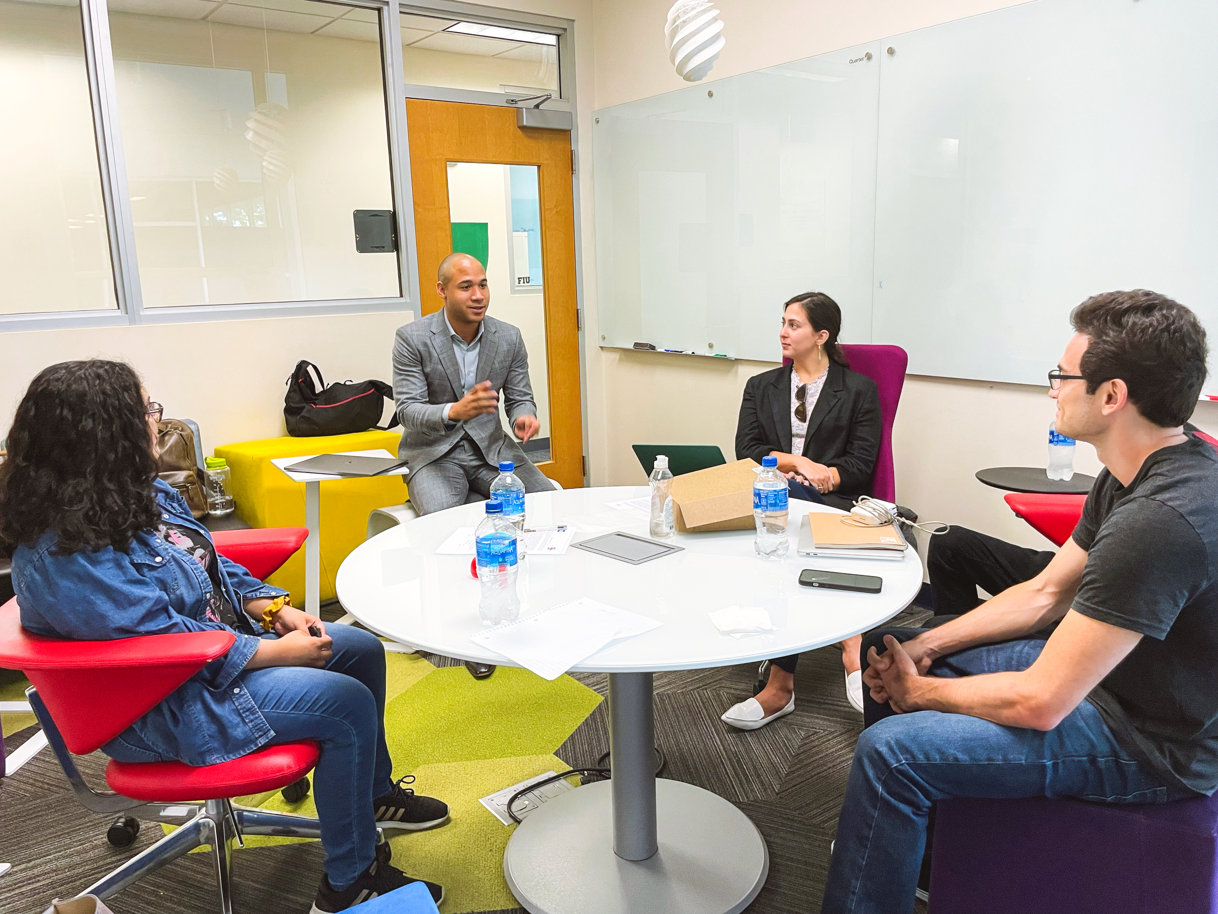 Group of professionals sitting at a round table in an engaging conversation